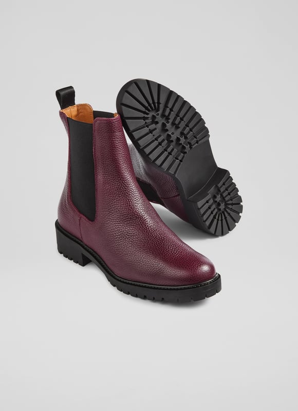 Make a bold statement with these Cadea ankle boots, perfect for casual wear. Crafted in Spain from luxurious textured leather, the tread sole boot features a round toe and a flat tread sole for ultimate comfort. These boots pair effortlessly with skinny jeans or a flowing midi dress for a stylish, versatile look.
