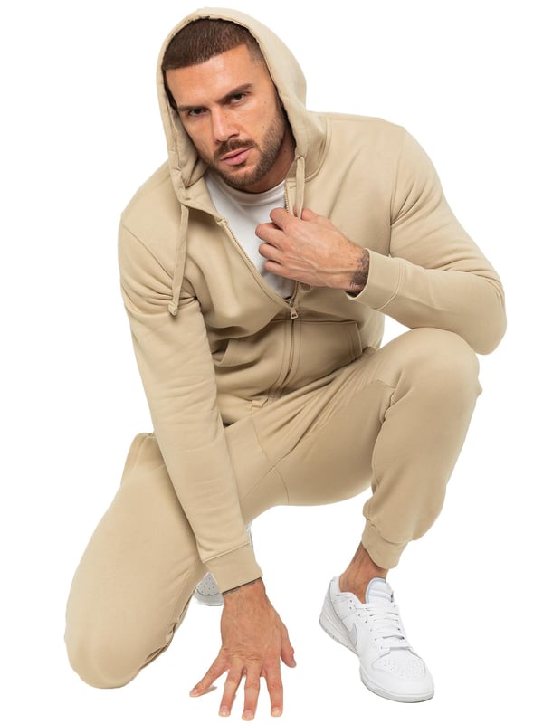 Enzo Mens Zip Hoodie Tracksuit Set. Regular Fit, Long Sleeve Zip Hoodie. Cuffed Wrists, Adjustable Drawstrings. Features EZ Logo On Joggers. Regular Fit, Cuffed Joggers. Elasticated Waistband With Adjustable Drawstring. Features 2 Side Slash Pockets & Single Welt Back Pocket. Ideal to use for Casual and Work wear.