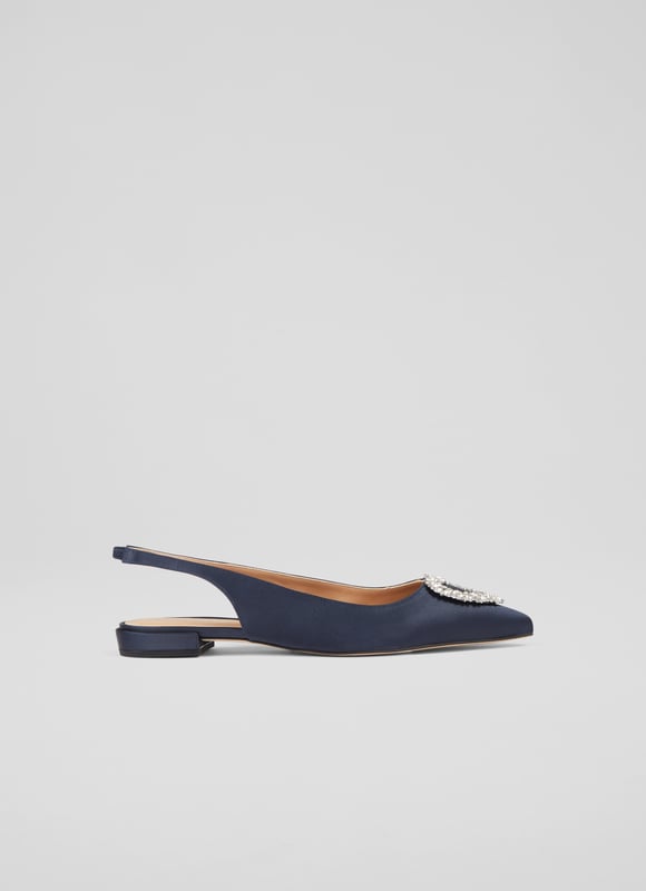 The definition of a 'fancy flat', the Luana slingbacks can elevate almost any look this spring/summer season with their subtle sparkle. Crafted in Spain from sumptuous navy blue satin, they have a pointed toe, a heart-shaped silver crystal brooch designed exclusively for LKB, an elasticated slingback, and a flat heel. Wear them to dress up a pair of jeans, or with dresses when you need a break from heels.