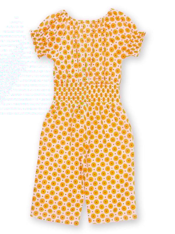100% organic cotton |  Proud to be certified by Control Union to the Global Organic Textile Standard (GOTS) |  Groovy dot all-over print |  Orange |  Double layer muslin fabric |  Side pockets |  Short sleeved |  Elasticated shirring at waist and sleeves |  3/4 length leg, culotte style legs |  Elasticated neckline |  Made in India |  Machine washable at 40 degrees, or at 30 degrees to be kinder to the planet