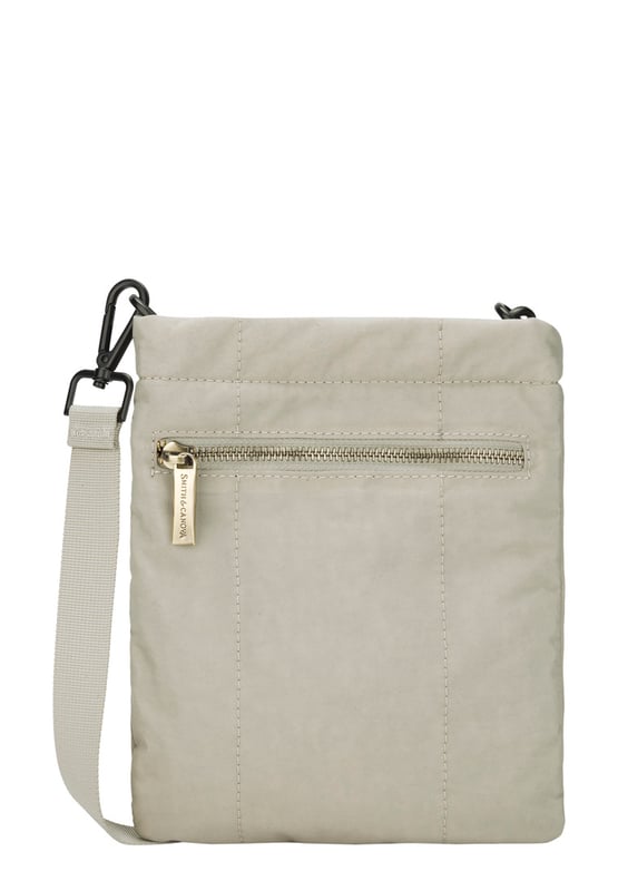 The perfect daily companion for carrying all your essentials. The Portrait Nylon Crossbody Bag features two internal main compartments, a flap over zip pocket to the front and fully adjustable strap with a clip off function. Features: , Zip top opening, Front flap over zip pocket, Rear zip pocket, SMITH & CANOVA antique brass logo, Branded antique brass zips, Adjustable crossbody strap (detachable), Two internal main compartments, Internal zip pocket Style Ref: 92685 STONE