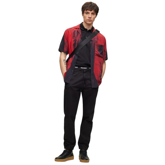Men's polo shirt from the HUGO brand. Plain-coloured pique polo with woven label on the left chest. Made of pure cotton.