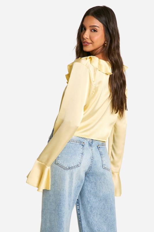 Satin Ruffle Tie Front Blouse A loose-fitting, lightweight garment with a feminine feel, a blouse is the ultimate wardrobe staple that never goes out of style. Floaty, chic, and far from basic, go from day to night with this classic piece. Whether you choose a floral blouse with jeans for a low-key vibe or drop jaws with a classic satin blouse and trousers, you'll be reaching for this style season after season. Seen in updated prints and classic neutrals, we're talking minimal effort, maximum payoff.Style: BlouseDesign: PlainFabric: SatinLength: RegularNeckline: V NeckSleeve Length: Long Sleeve