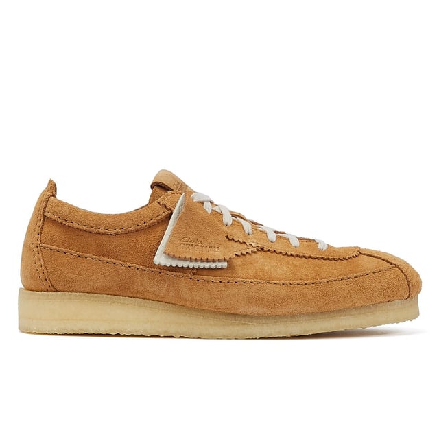 Introducing a premium mid-tan suede upper shoe with a sleek trainer silhouette, featuring tonal top-stitch details, complemented by a comfortable crepe sole. Finished with two Clarks Originals fobs.