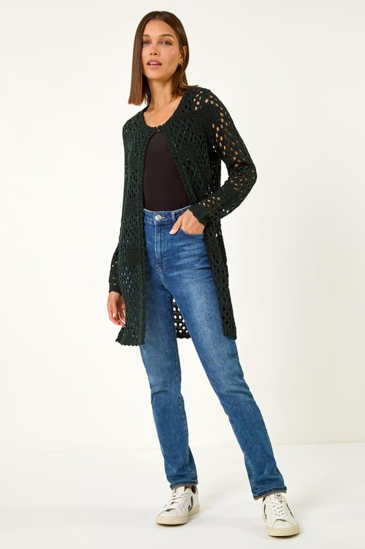 Shimmer Longline Knit Cardigan from Roman. Add a touch of shimmer to your Autumn wardrobe with this stunning longline cardigan. Featuring intricate stitch details, this cardigan is designed with long sleeves and a unique hook and bar fastening at the neck. The shimmer effect adds a touch of elegance to any outfit. Pair it with jeans and sandals for a casual yet chic look that will sparkle all season long!