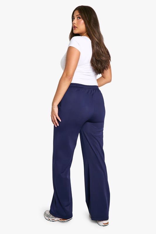 Straight fit joggers for a relaxed silhouette
        Side stripes add a sporty, contemporary touch
        Comfortable jersey fabric for all-day wear
        Wide leg design for effortless movement
        Versatile style suitable for various casual occasions
    
    Embrace comfort without compromising on style with these plus-size joggers from Boohoo. The straight fit and wide leg design offer a flattering silhouette while ensuring unrestricted movement. The side stripes lend a trendy, athletic-inspired look that's perfect for the fashion-forward woman. Pair these versatile joggers with a fitted white tee and trainers for a laid-back daytime ensemble, or dress them up with a cropped jacket and statement jewellery for a chic evening out with friends. The soft jersey fabric makes these joggers ideal for lounging at home, running errands, or attending casual family gatherings. For a coordinated look, match with the hoodie as shown in the image, completing an outfit that's both cosy and stylish. These joggers are a must-have addition to your wardrobe, offering endless styling possibilities for the modern, confident woman who values both comfort and fashion.