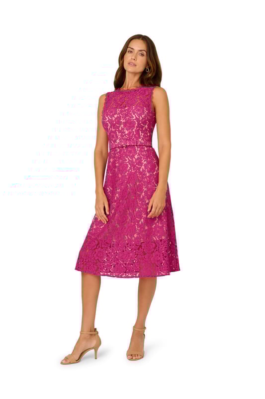 Dressy by day, flirty by night, this lace dress is a charming look. This fit and flare dress features a crew neckline, sleeveless bodice with sheer lace at the yoke, and a belted waist. Partially lined with contrasting fabric, this midi dress is crafted from lace that is sheer at the neck and hem. This party dress is closed with a zipper at the centre back. Complete the look for a day at the office or a night out with nude heels and sparkling jewels.
