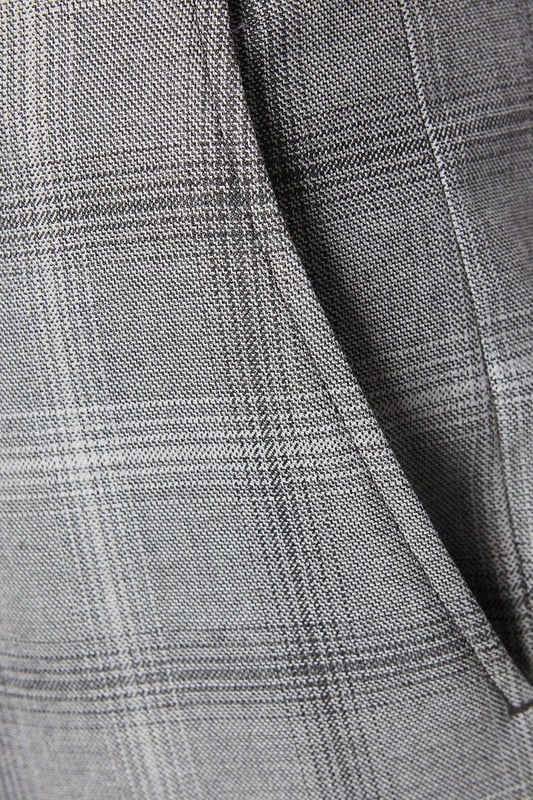 Slim fit tailored trousers with a sleek, tapered silhouette
Crafted from a fine grey check patterned fabric
Flat front styling with slant side pockets
Belt loops to accommodate a smart leather belt
Hem designed to sit neatly on the shoe

Exuding refined sophistication, these slim fit trousers from Burton are the epitome of smart tailoring. Pair them with a crisp shirt and blazer for a polished look at formal occasions or dress them down with a knitted jumper for elevated weekend styling. The slim cut flatters the frame while the grey check pattern adds a touch of classic British flair, making them a versatile choice for the modern gentleman's wardrobe.