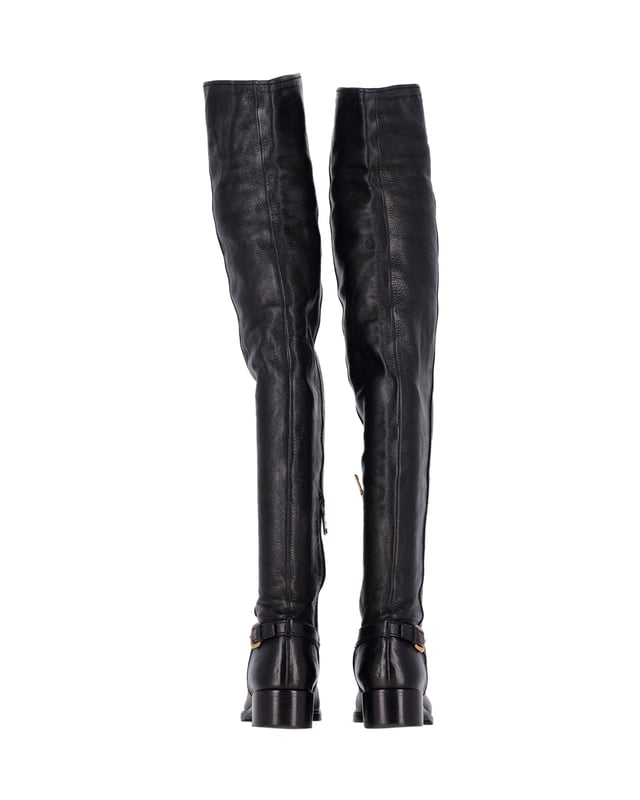 VINTAGE, RRP AS NEW
Step into style with the Prada Over-The-Knee Buckled Boots. These boots are crafted from soft and supple black leather, offering both comfort and luxury. The over-the-knee length creates a striking silhouette. With a low block heel and round toe, these boots boast a practical design. The gold-tone buckle on the side adds a classic and subtle detail, making these boots perfect for any occasion.

Prada Over-The-Knee Buckled Boots in Black Leather
Condition: Very good
Sign of wear: Moderate wear on the soles, minor creasing
Material: Leather
Color: Black
Size: IT37 / US7 / UK4
SKU: 360946 / HNPUGBSH360946W