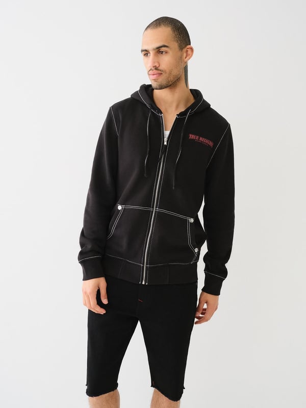 Stay warm in the on-trend Painted Horseshoe Zip Hoodie. This fleece hoodie features a zip-up front, drawstring hood, Big T stitching, long sleeves, and a split kangaroo pocket. Finished with a statement-making painted horseshoe graphic on the back. 