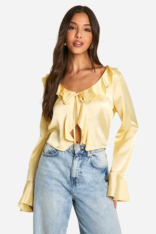Satin Ruffle Tie Front Blouse A loose-fitting, lightweight garment with a feminine feel, a blouse is the ultimate wardrobe staple that never goes out of style. Floaty, chic, and far from basic, go from day to night with this classic piece. Whether you choose a floral blouse with jeans for a low-key vibe or drop jaws with a classic satin blouse and trousers, you'll be reaching for this style season after season. Seen in updated prints and classic neutrals, we're talking minimal effort, maximum payoff.Style: BlouseDesign: PlainFabric: SatinLength: RegularNeckline: V NeckSleeve Length: Long Sleeve