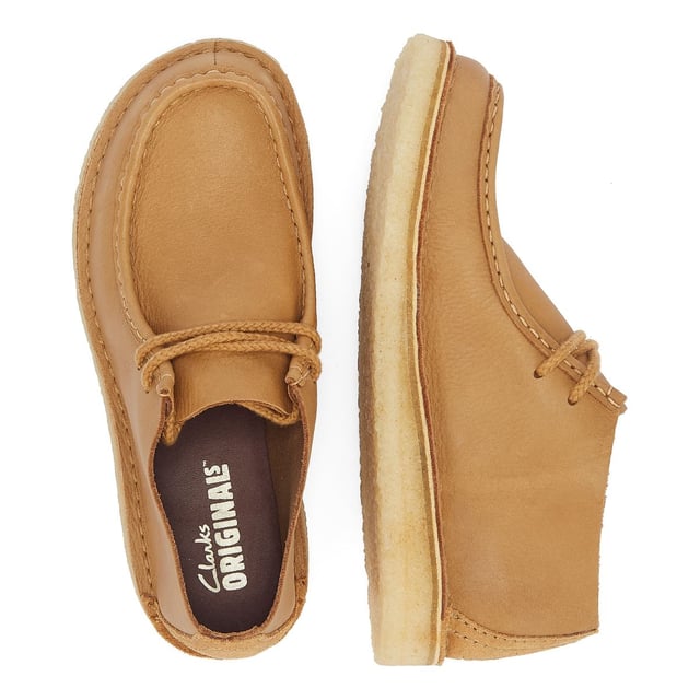 Introducing the Nomad shoe, a fusion of Wallabee and Desert Trek styles, boasting hand-stitched details. Crafted from premium mid tan leather upper for durability and style. Finished with a lightweight pebble crepe sole for added comfort and traction.
