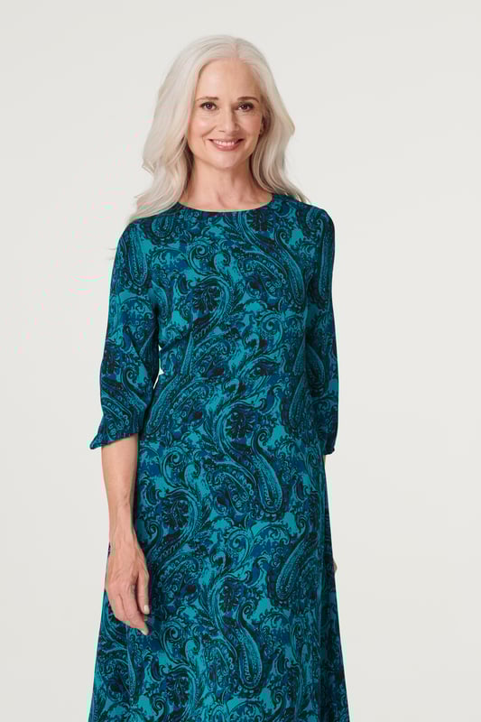Add an chic asymmetric style to your dress collection with this chic paisley midi. It has a round neck, 3/4 sleeves, a keyhole back, a cinched waist and an elegant midi length skirt with a hanky hem detail. Pair with neutral heels for a daytime style you can wear for anything from lunch with the girls to a day at the races.