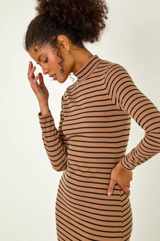 High Neck Stripe Bodycon Midi Dress from Roman. Elevate this Autumn Winter with our midi dress adorned in a timeless stripe print. Designed to finish at midi length, this dress showcases a flattering bodycon shape, complete with a high neckline and long sleeves to keep you warm throughout the colder season. Crafted from a cosy ribbed fabric, this dress is an essential to stay both stylish and comfortable. Pair it effortlessly with a denim jacket and boots for a complete fall look.