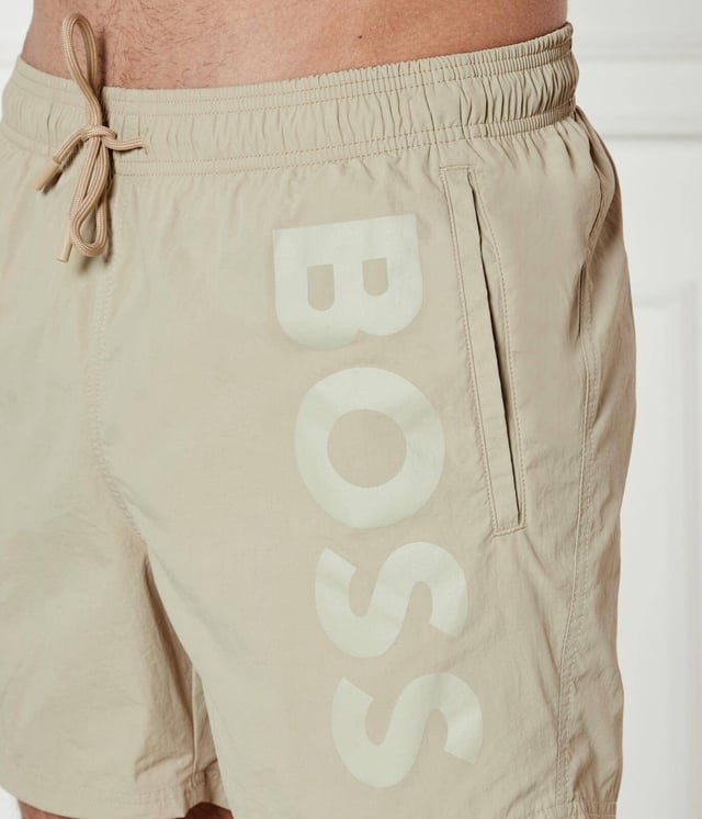 STYLE OCTOPUS – 50515296
Statement swim shorts with full lining by BOSS, designed in soft quick-drying poplin featuring a vertical logo print on the left leg. For our BETTER BOSS products, we always use at least 60% better raw materials. This product is made from at least 60% recycled polyamide. By using recycled polyamide, we aim to save resources by making use of existing plastic material. Recycled nylon is usually made from pre-consumer spinning or fabric waste and may also come from post-consumer industrial fishing nets. We only use raw materials with a verified chain of custody to ensure the use of certified recycled polyamide.
100% Polyamide (recycled), Lining: 100% Polyester
30°C fine wash
Do Not Bleach
Do Not Tumble Dry
Do Not Iron
Do not chemical dry clean
The model wears a size M and is 189 cm tall with a, 98 cm chest, 80 cm waist and 94 cm hips.