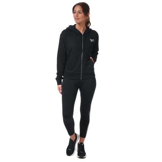 Womens Reebok Identity Zip- Up Track Top in black.- Drawcord-adjustable hood.- Long sleeves with ribbed cuffs.- Full zip fastening.- Kangaroo pocket.- Ribbed hem.- Small logo.- Oversize fit.- Main Material: 80% Cotton  20% Polyester (Recycled). Rib Part: 95% Cotton  5% Elastane. - Ref:GL2561