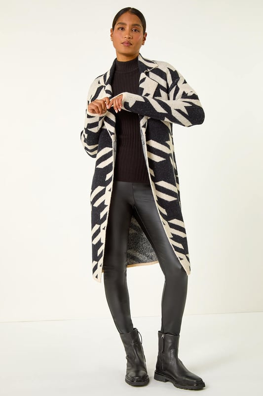 Houndstooth Coatigan from Roman. Make a stylish statement this Autumn Winter with our houndstooth knit coatigan. Featuring a flattering edge-to-edge opening and long sleeves to keep you warm, this luxurious mix of soft fabrics is designed in a striking houndstooth pattern that is perfect for your trendy fall outfits. Finishing below knee length, it's a must-have piece to elevate your wardrobe. Pair with jeggings and ankle boots for a complete look.
