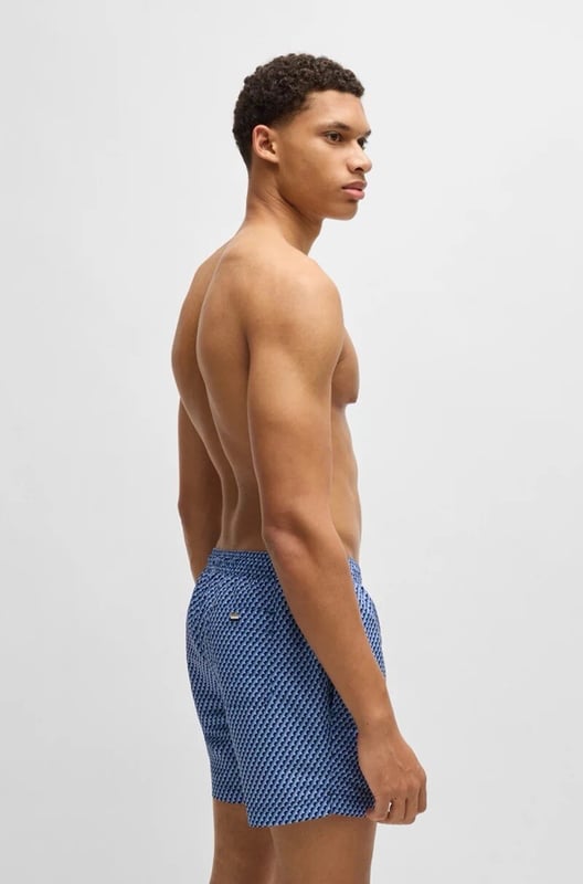 The model wears a size M and is 189 cm tall with a, 95 cm chest, 73 cm waist and 94 cm hips
50518968
Refined swim shorts by BOSS, designed with an all-over seasonal print. This fully lined pair is trimmed with a drawcord and logo label. This product is partly created with recycled polyester. We at HUGO BOSS prefer recycled polyester from pre- and post-consumer textile waste and do our best to phase out polyester from PET bottles. The aim of using recycled materials is to save valuable resources.