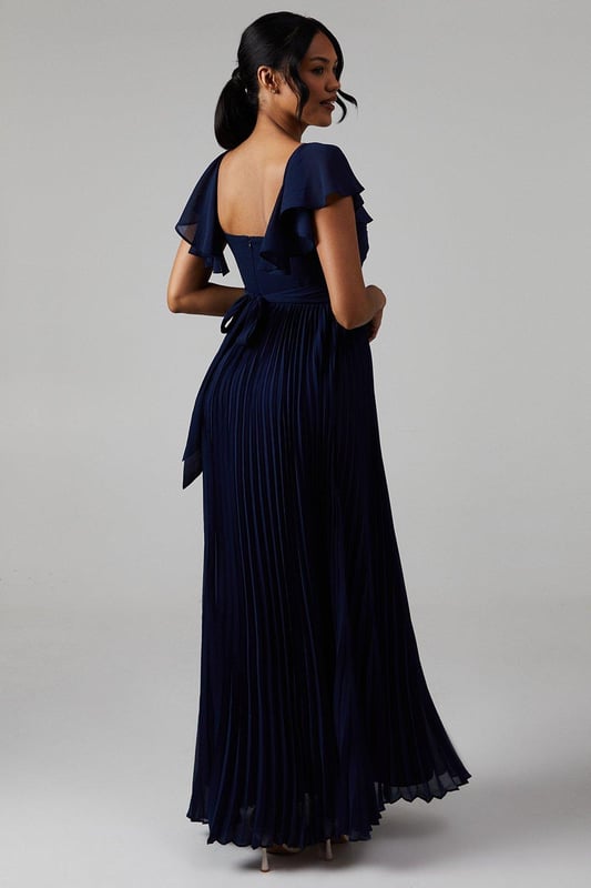 Ethereal crinkle chiffon fabric for a romantic look
        Sweetheart neckline with elegant twist detail
        Graceful angel sleeves add a whimsical touch
        Floor-length maxi silhouette for a sophisticated appearance
        Pleated skirt creates beautiful movement and texture
    
    This enchanting bridesmaids maxi dress from Coast is the epitome of grace and elegance. Perfect for your role in the bridal party, the crinkle chiffon fabric drapes beautifully, creating a soft and romantic silhouette. The sweetheart neckline with its delicate twist detail draws attention to the dcolletage, while the angel sleeves add a touch of whimsy and femininity. The pleated skirt flows gracefully to the floor, ensuring a stunning entrance as you walk down the aisle. Pair with delicate drop earrings and a simple bracelet to complete your bridesmaid ensemble. This dress is designed to complement the bride while allowing you to shine in your supporting role on this special day.
