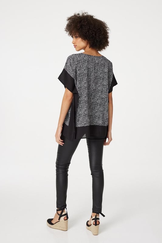 Make a statement with this leopard print poncho blouse top. It has a round neck, short sleeves, an oversized fit and a thigh length hem. Pair with fitted trousers and heeled wedges for a standout style that's perfect for date night or drinks with the girls.