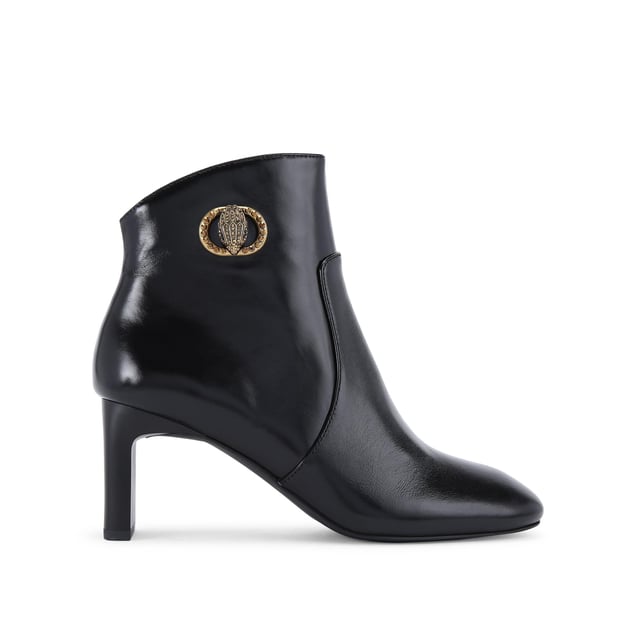 This Kurt Geiger Chelsea Square Toe Bootie is crafted from a black leather. There is an antiqued brass buckle with eagle head that is embellished with crystals sat on the outer side of the ankle. Heel height: 7.5cm.