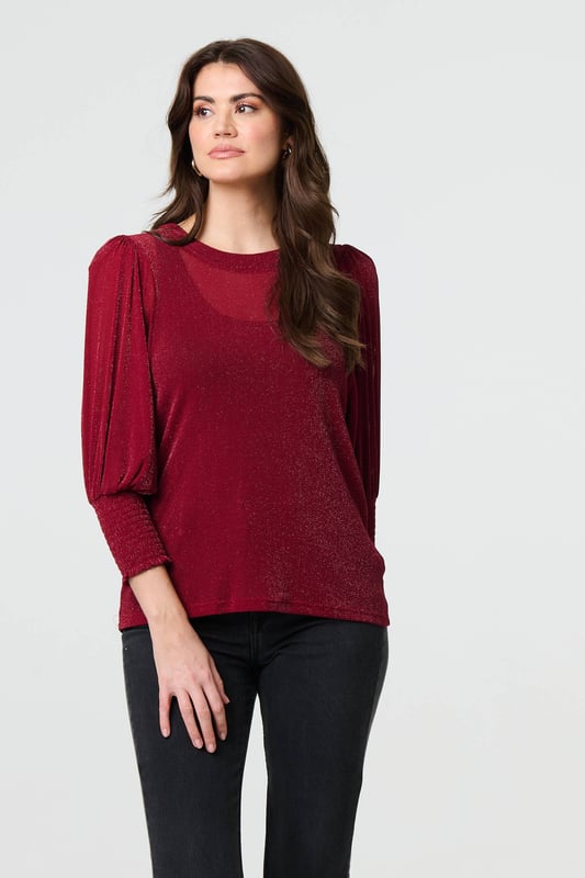 Dress for a smart-casual occasion with this glittery top. It has 3/4 puff sleeves and a hip length hem, along with a round neck and a relaxed fit. Just pair with fitted jeans and heels for the perfect laid-back occasion wear outfit.