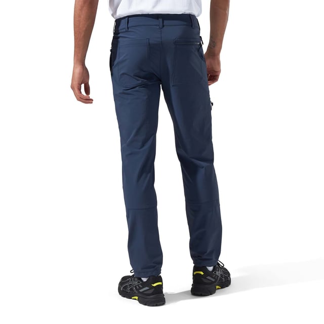 Men's Berghaus Tetratrack Pants in dark blue.- Snap closure on the waist.- Zipped hand pockets.- Side pockets.- Belt loops.- Toggles at the leg.- The DWR face fabric ensures droplets bead on the surface of the fabric, giving water resistant protection.- With more than 50% recycled content and more than 90% bluesign® APPROVED fabric, this product meets our MADE KINDER criteria which helps ensure that our gear is more responsibly made. Ref: 4A001414R14.