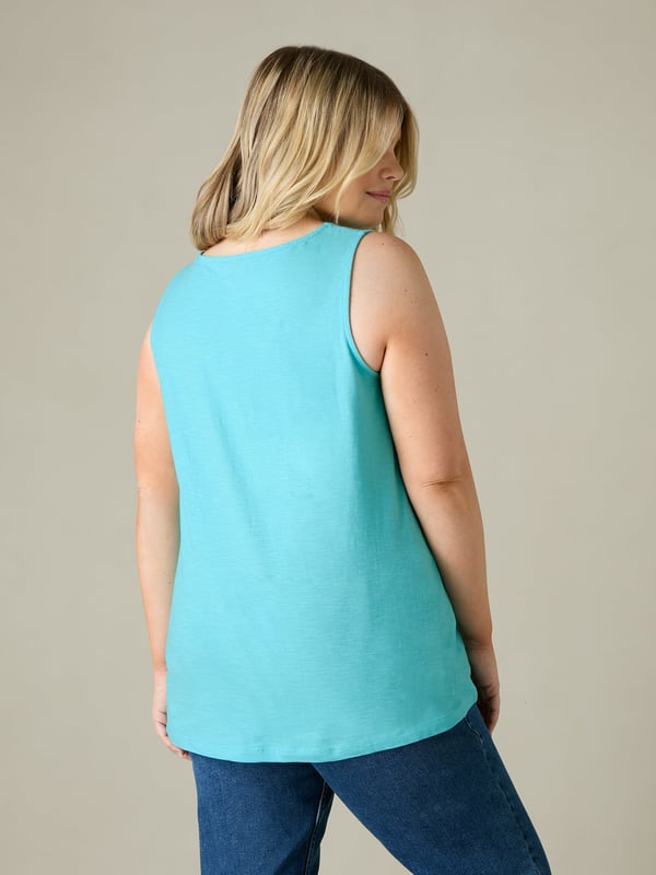 This easy-to-wear vest, cut from breathable cotton, is designed to be the most flattering piece in your wardrobe. In the softest of turquoise slub cottons, with a softly rounded neckline and a centre front seam to give a gentle A-line silhouette to the body, its nice and loose on the tummy, and is the perfect basic staple piece that youll come back to time and time again.