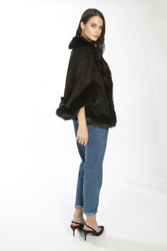 Immerse yourself in effortless luxury with this elegant, decadent faux suede cape with matching faux fur trim. Our luxurious cape can be worn to complete a modern layered look on those chilly days.