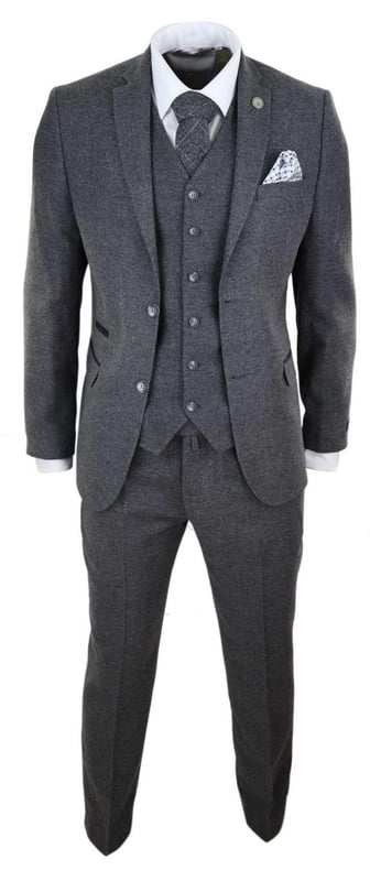 A grey suit is a key staple in every mans wardrobe and this one is no exception to this unwritten rule. Sharp, sleek and sophisticated, look the part with this premium 3 piece grey wool tweed suit, that features a slim fit cut, with a closer fit across the chest and narrower tailored trousers. the two-button jacket hangs beautifully and has a half canvas construction that moulds to your body shape the more you wear it. Contrasting velvet pocket piping, buttoned cuffs and a single back vent lend the suit a classic touch of refinement. A matching tweed waistcoat completes the 3-piece with a single breasted down style with classic tailored pockets and a back adjuster to ensure you can create your ideal fit. The suit is evergreen and contemporary at the same time and allowing you to look the best all day. Pair it with a matching waistcoat, a white shirt and shoes for a dapper finish.
