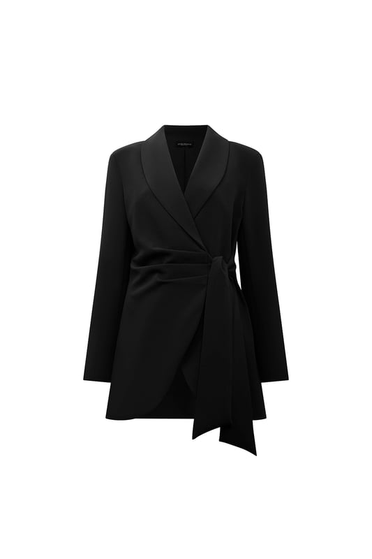Chic James Lakeland Blazer with a shawl lapel and glamorous front ruching. Features a hidden front button and long sash belts for tying. Curved hems create a cinched waist illusion. Three-quarter sleeves and slim silhouette tailoring make this a sleek, stylish piece.