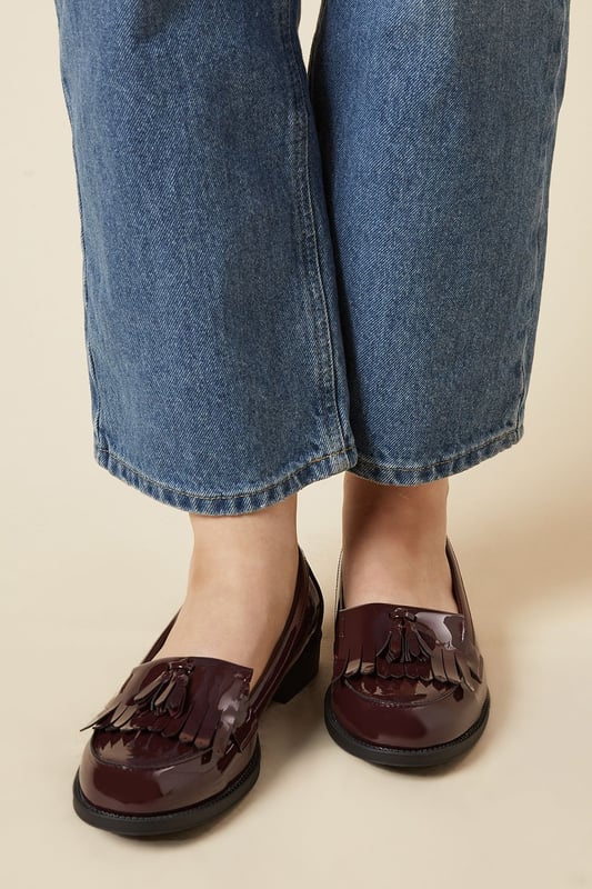 Faux leather loafers with a wide fit for added comfort
Sleek and polished design with a fringed tassel detail
Flat sole offers a versatile wear from day to night
Slip-on style for easy on and off
Synthetic lining and outsole for durability

Exude effortless sophistication with these Wide Fit Leigh Fringe Loafers from Dorothy Perkins. The faux leather construction lends a luxurious touch, while the fringed tassel detail adds a playful twist to the classic silhouette. Designed with a wide fit, these loafers offer ample room for all-day comfort. Pair them with tailored trousers for a polished office look or team them with a flowy dress for a chic weekend ensemble. Their flat sole ensures versatility, allowing you to transition seamlessly from desk to dinner.
