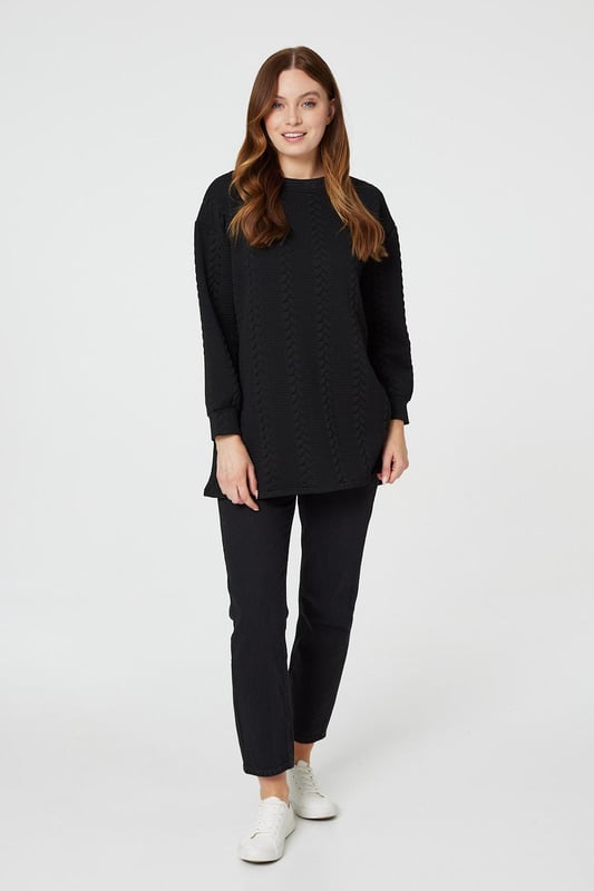 Get cosy in this cable knit oversized jumper. It has a round neck, long sleeves, an oversized longline shape and a thigh length hem. Pair with jeans or leggings for a classic style you can keep in your capsule closet for years to come.
