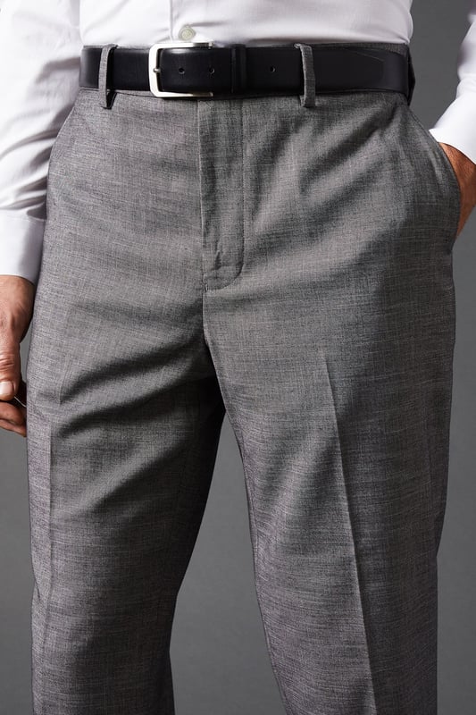 Tailored fit for a refined silhouette
        Sharkskin texture adds subtle sophistication
        Belt loops for versatile styling options
        Side pockets for practicality
        Pressed centre creases for a crisp look
    
    These mid grey sharkskin trousers offer a perfect balance of style and comfort, ideal for the modern gentleman who appreciates classic tailoring. The tailored fit sculpts your silhouette while allowing ease of movement, making them suitable for long days at the office or evening events. Pair them with a crisp white shirt and matching jacket for a complete suit look, or dress them down with a light jumper for smart-casual occasions. The versatile mid-grey hue allows for effortless coordination with various shirt colours and accessories. Whether you're heading to an important business meeting, a wedding, or a sophisticated dinner, these trousers will ensure you look polished and feel confident. Their timeless design makes them a wardrobe staple that will serve you well for years to come.