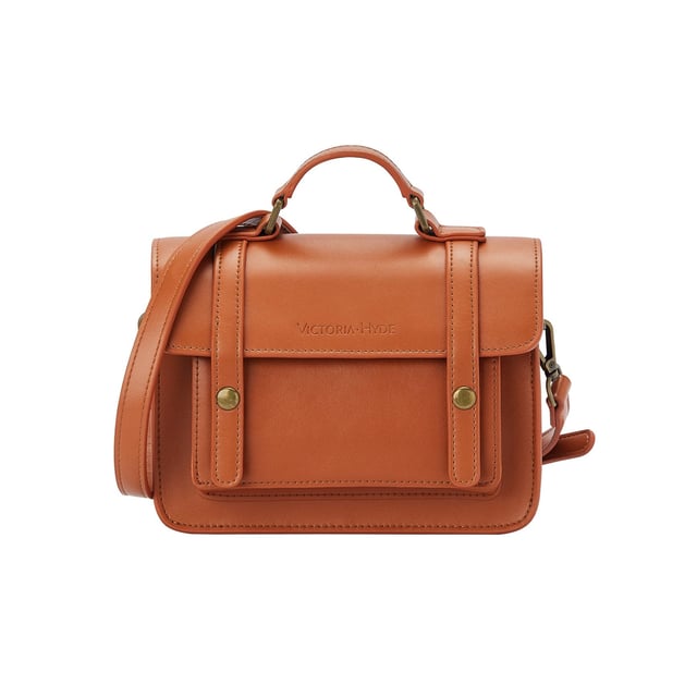 Tradition meets modernity! With the brand new Satchel handbag, Victoria Hyde London quotes traditional satchels and adapts the style of the past to our modern times. The brown handbag opens with two golden buttons. When you open the bag, three compartments, including one with a zip, immediately catch your eye. This means your essentials are always perfectly stowed away and organised. Your new favourite piece can be worn casually as a crossbody bag, cool over the shoulder or elegantly in the hand. The golden accents of this brown handbag stylishly round off the look of the bag. Dimensions: 19cm x 15cm x 6cm, Length of the carrying strap: 96.5cm,  Height of the carrying strap: 47cm