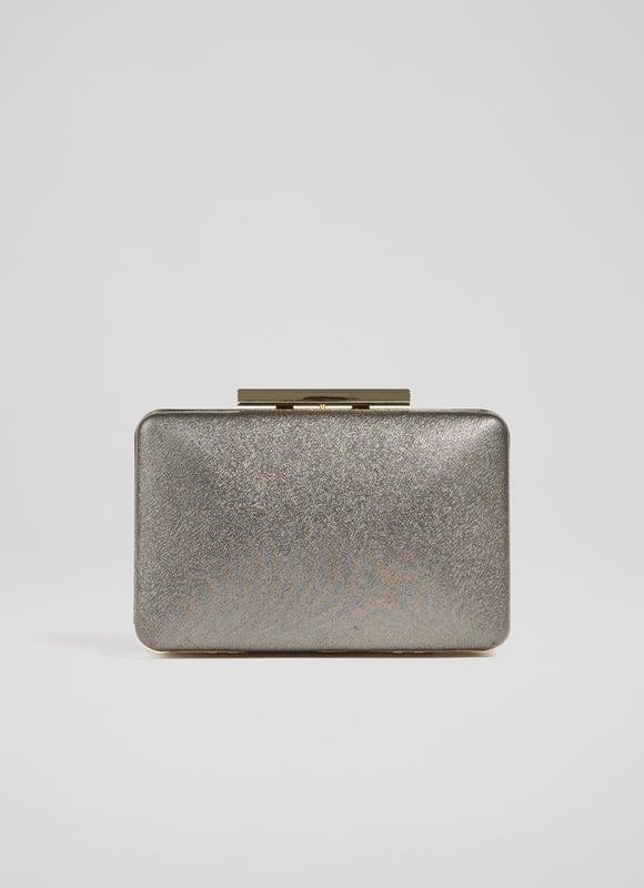 A modern interpretation of the classic box clutch, Dotty is designed for long-awaited parties. Crafted in Spain from beautiful fine glitter (which doesn't shed) in a luxurious bronze hue, it has a tapered, 3D rectangular shape, a chain shoulder strap and inside slip pocket. Wear it to add a subtle bit of shimmer and shine to any winter look.