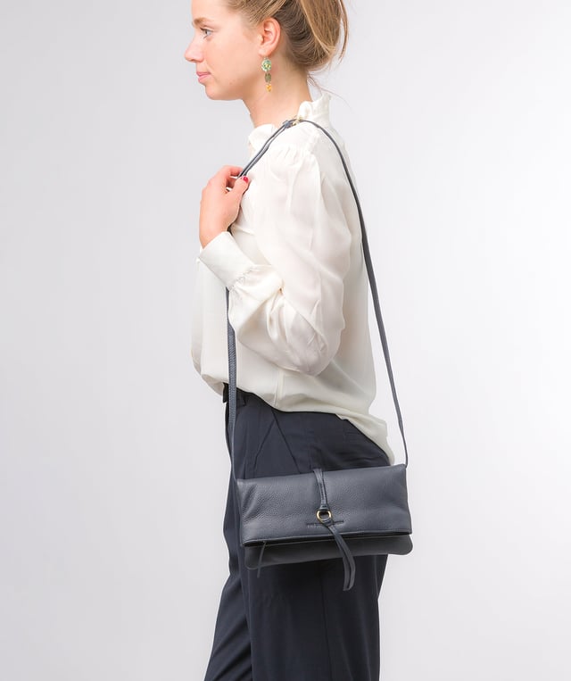 The 'Selene' cross body clutch bag from the Pure Luxuries Marylebone Collection is handcrafted from high-quality, genuine Nappa leather with a natural super-soft touch. The fold-over top secured by two magnetic press studs, opens to reveal a zipped main compartment and a slip pocket. The interior is lined with 100% cotton and includes two slip pockets to help maintain an organised bag. Comes with a matching and adjustable slim leather strap, with a maximum drop length of 65cm. The strap is also removable, transforming the bag into a clutch bag. Features gold-coloured metal fittings and zip. The Pure Luxuries logo is embossed for an effortless and sophisticated finishing touch.