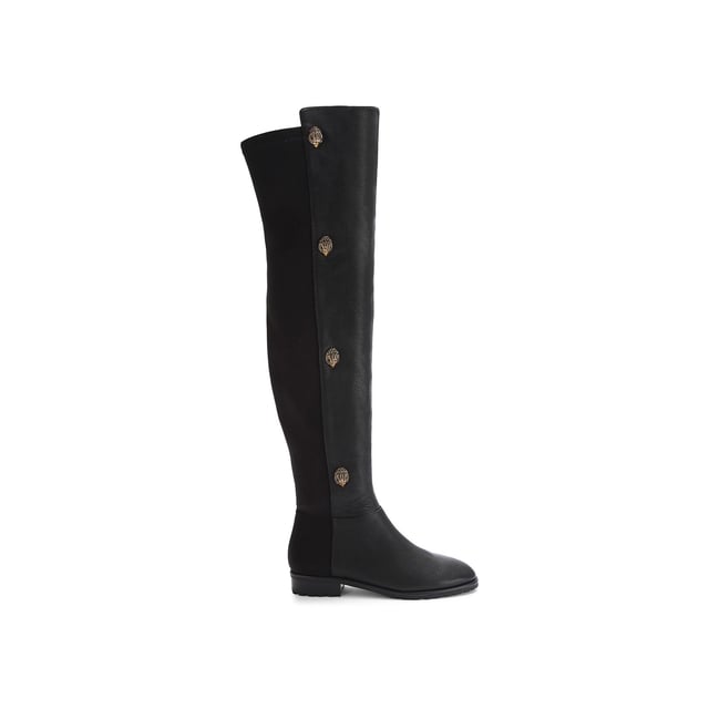 The Kurt Geiger Shoreditch boot features a grained leather upper which sits above the knee. The outer side of each boot features four antiqued brass eagle heads with crystals.