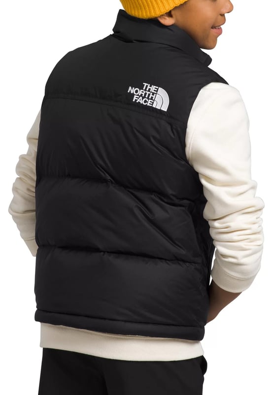 The North Face Nuptse has been delivering game-changing warmth since 1992 and no other jacket has journeyed so naturally from the mountains to city streets. - - .   The Teens' 1996 Retro Nuptse Gilet is a modern reincarnation of the icon, built for young adults. - - .  We’ve kept most things the same: the same boxy silhouette; the same shiny ripstop fabric; the same exposed zip and diagonal hand pockets and, of course, the same oversized baffles. - - .  The only change is upgrading to 700-fill of responsibly sourced down. - - .  It's also made with recycled materials, making it kinder to nature. - - . Shell: 100% Nylon, Lining: 100% Polyester, Filling: 90% Down, 10% Waterfowl Feathers.