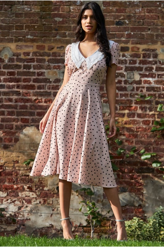 If you are looking for a cute little summer dress that is simple and stylish at the same time, then this polka dot tea dress with a collar from Goddiva is the one you want. The feminine cut accentuates your curves, while the short sleeves keep you cool on hot summer days! This classic polka dot day dress with a large collar is the perfect outfit for any summer day, from a picnic to that garden party you've been wanting to attend. This Tea Dress is designed with a high neckline, short sleeves and a fitted bodice, cinched at the waist with an eye-catching beige polka dots pattern. A style that will never not be fashionable and is an absolute essential to your summer wardrobe. This stunner of a short spring/summer dress is not only perfect for the obvious occasions, but is also a winner for date nights and of course the first thing you need to pack for your beach getaways. Team with sandals or wedges and let the dress do the talking.
