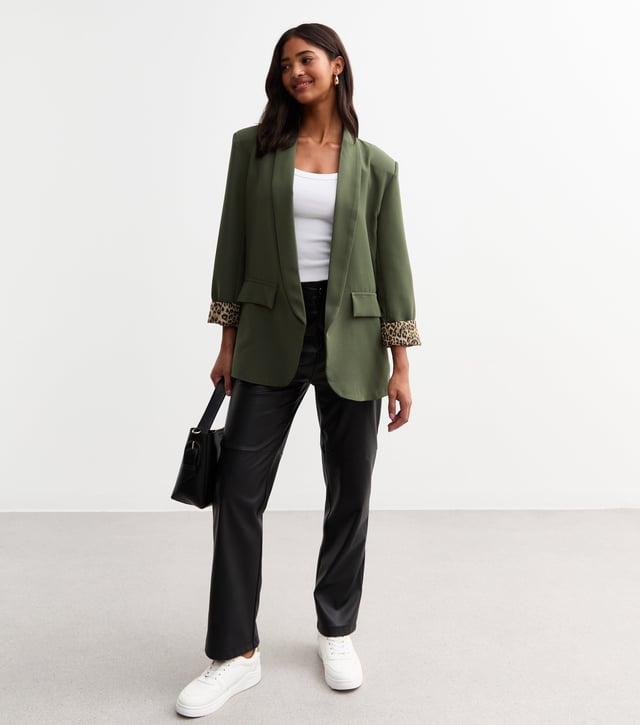 Elevate your style with our sleek Khaki Contrast Animal Edge to Edge Blazer. Stand out with its unique animal print contrast, perfect for the fashion-forward woman. This versatile blazer can be dressed up or down, making it a stylish addition to any wardrobe.