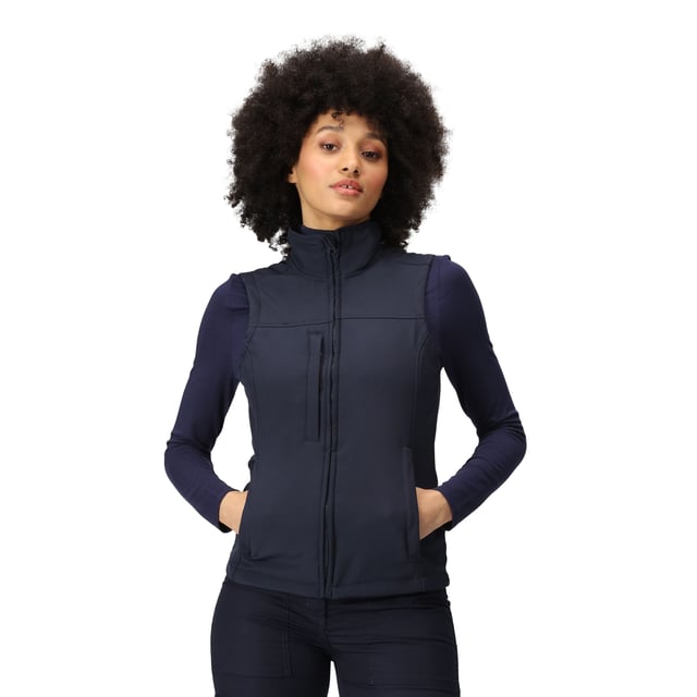 Material: 96% Polyester, 4% Elastane. Fabric: Soft Touch, Softshell, Stretch, Woven. 270gsm. Design: Plain. Fit: Shaped. Quick Dry, Water Repellent, Wind Resistant. Fabric Technology: Warm-Backed. Sleeve-Type: Sleeveless. Neckline: Zip. Pockets: 2 Lower Pockets, 1 Chest Pocket, Zip. Fastening: Zip. Hem: Adjustable, Shockcord Hem.