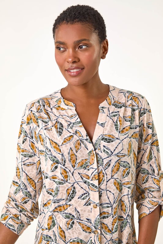 Button Detail Leaf Print Blouse from Roman. Stand out this Autumn in this charming leaf print blouse. Featuring a striking all-over leaf design, this blouse comes complete with a sophisticated button-through centre front for easy wear. The addition of tabs on the sleeves adds a touch of casual chic to this statement piece. Pair with your favourite jeans and trainers for a stylish and trendy look that will take you from day to night effortlessly.