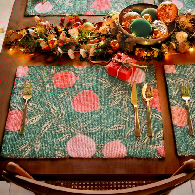 Displayed in all its glory, the Pomegranate set of four placemats is the perfect addition to your home this festive period. Digitally printed for exceptional clarity on a durable woven polyester fabric, the opulent, juicy fruits intertwine with gold leaves, complimenting the warming green background. A refreshing alternative to traditional festive decor, this beautiful set brings richness to the Christmas dining table and will look fantastic all year-round.
