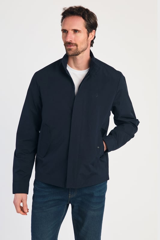 This Harrington Style Jacket by Kensington Eastside features a button-up collar, pop button sleeves, and a durable PVC coating. The checked mesh inner lining enhances comfort, while two side pockets and an embroidered logo add style and functionality, making it a perfect choice for casual wear.