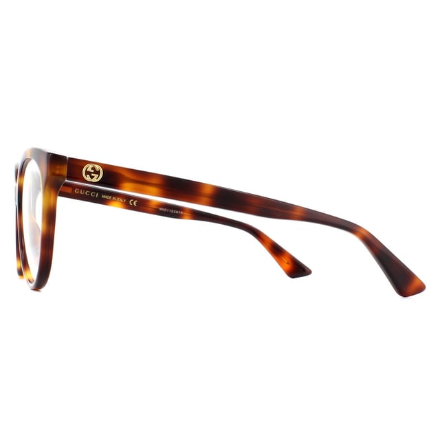 Gucci Glasses Frames GG0329O 002 Light Havana Women are an oversized round style with upswept corners for a subtle cat eye finish. The thick acetate frame is embellished with interlocking GG logos on the temples.