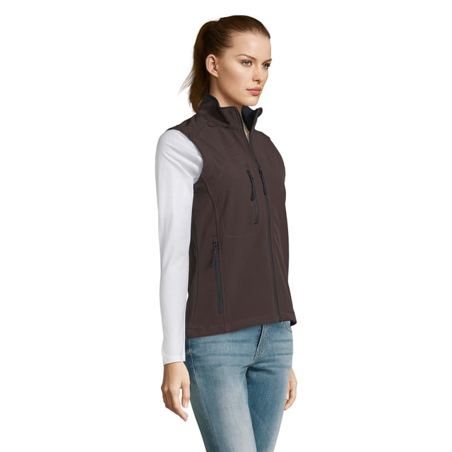 Stretch soft shell fabric has a polyester/elastane outer, membrane and a polyester fleece backing. Mesh lined front body panels. Breathable, windproof and water resistant. Shaped fit. Taped neck. Collar high full zip with inner storm flap and chin guard. Two front zip pockets and one right chest zip pocket. Adjustable drawcord at hem. Drop tail. Access for decoration. Material: 94% polyester/6% elastane. Ladies size: S(8/10), M(12), L(14), XL(16), XXL(18).