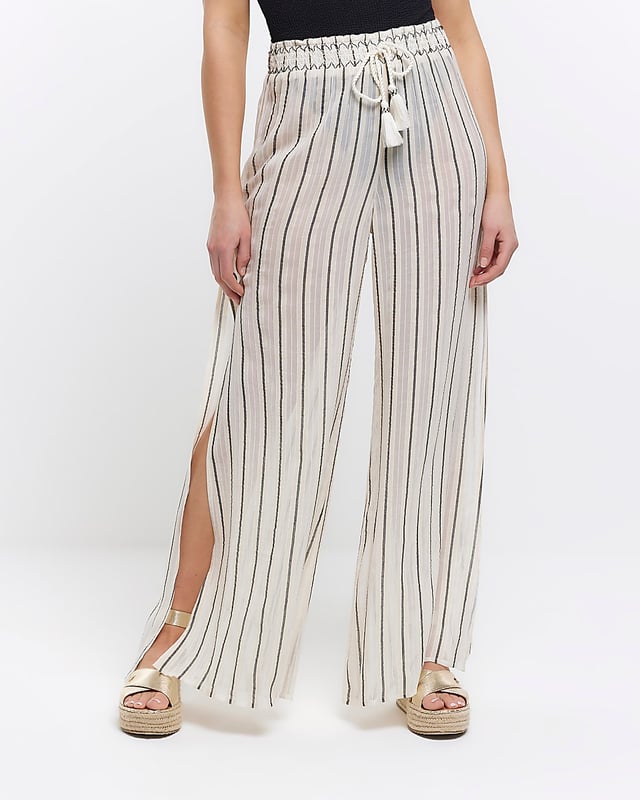 Stripe print, Mid rise, Flared design, Split hem, Elasticated waist, Made with at least 50% sustainable viscose, Our model wears a UK 8 and is 175cm/5'9'' tall