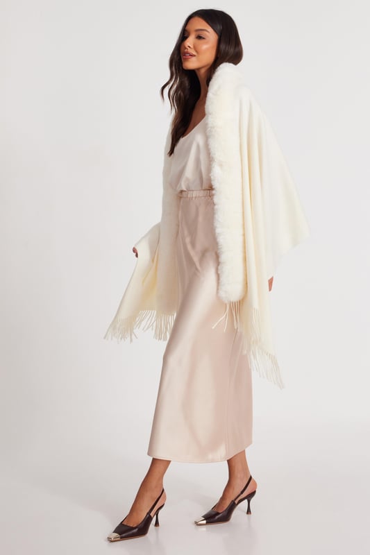 - Knitted - Faux fur collar - Tassel finish - Cape style - Always check the care wash label - Cool hand wash with mild detergent