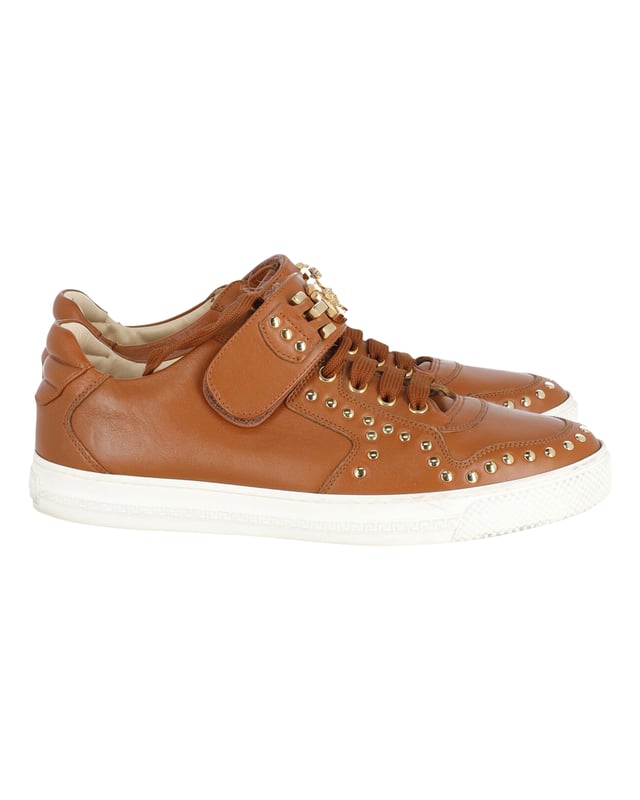 VINTAGE, RRP AS NEW
Brimming with fabulous details, these Versace sneakers are crafted from leather into a low-top silhouette and feature lace-up vamps, gold-tone studs and the Medusa logo on the ankle straps. Comfortable soles and trendy appeal make these sneakers a must-buy.
Versace Medusa Studded Low Top Sneakers in Tan Leather
Condition: very good
Sign of wear: light dirt on soles, minimal creasing on exterior
SKU: 245398   
Color: brown | tan
Material: Leather
Size: IT40/EU40/UK7/US10